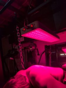 Man laying under a light therapy panel